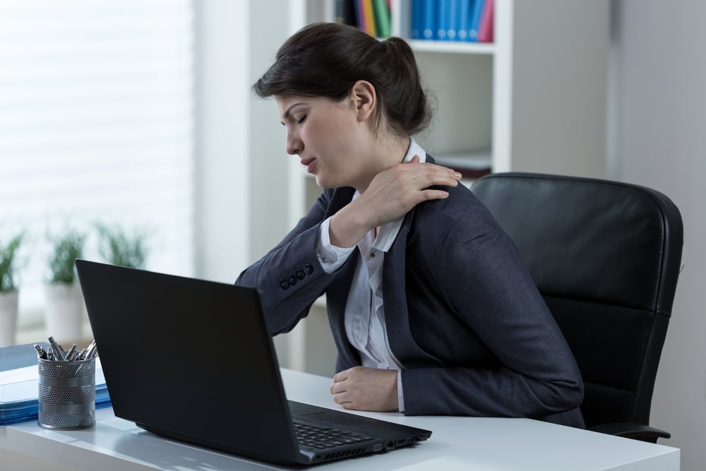 Businesswoman leading sedentary lifestyle causing back pain-1