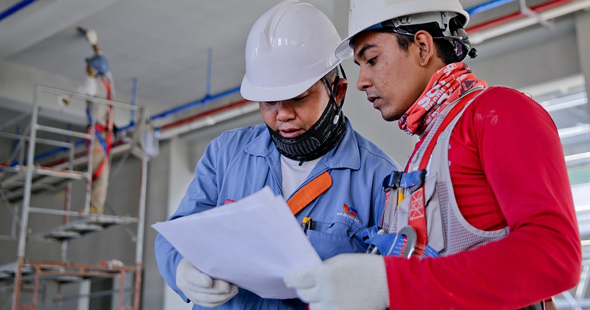 Workers conducting a health and safety audit in the workplace.