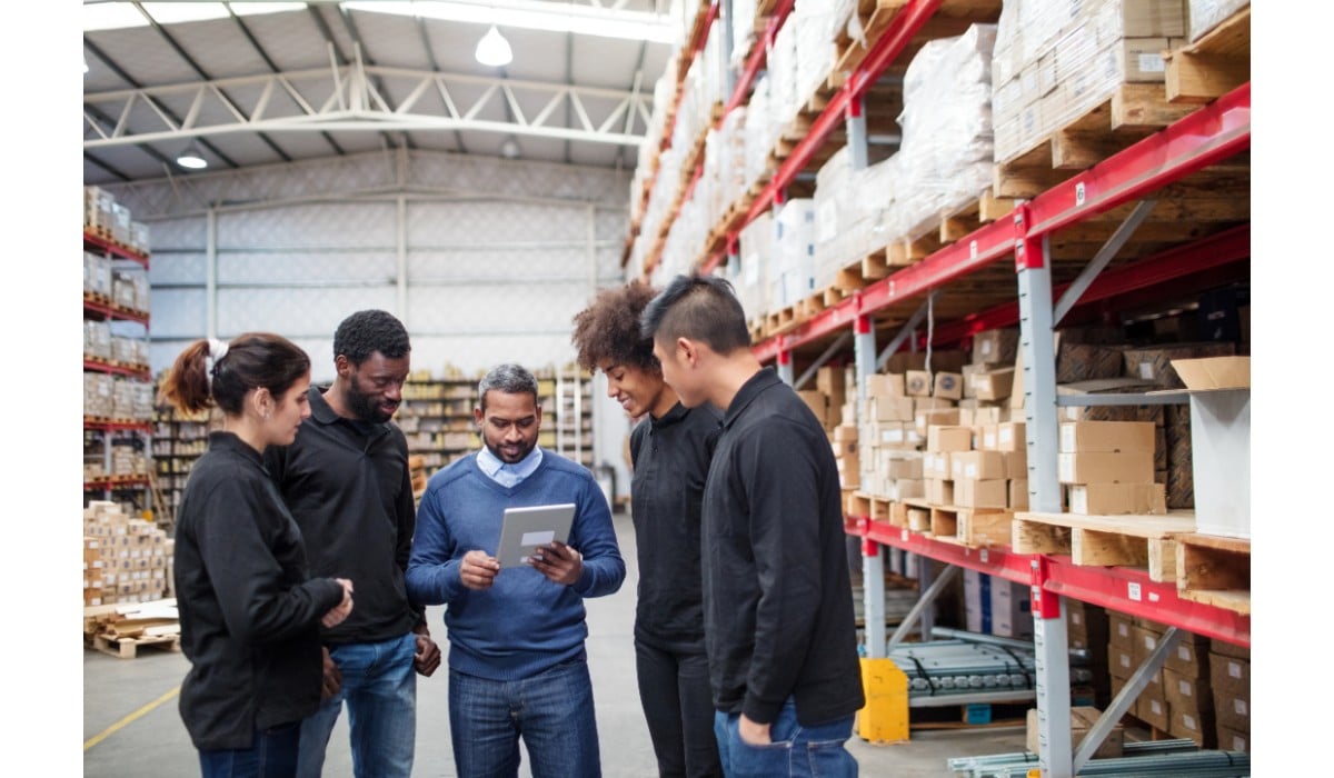 workers in warehouse examine iso 45001 clauses