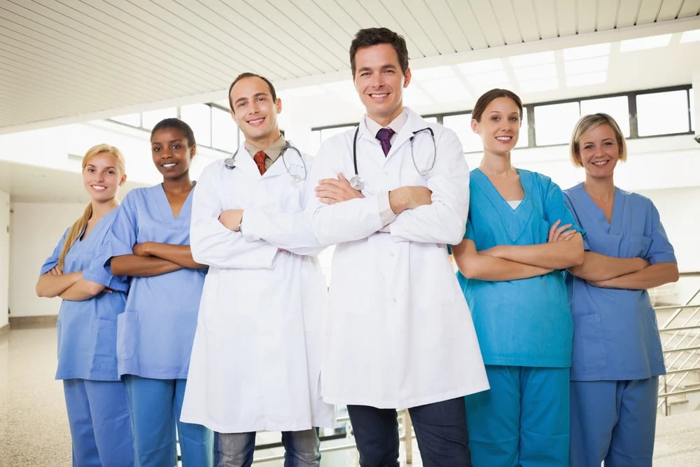 Doctors20with20nurses20with20arms20crossed20in20hospital20corridor 1