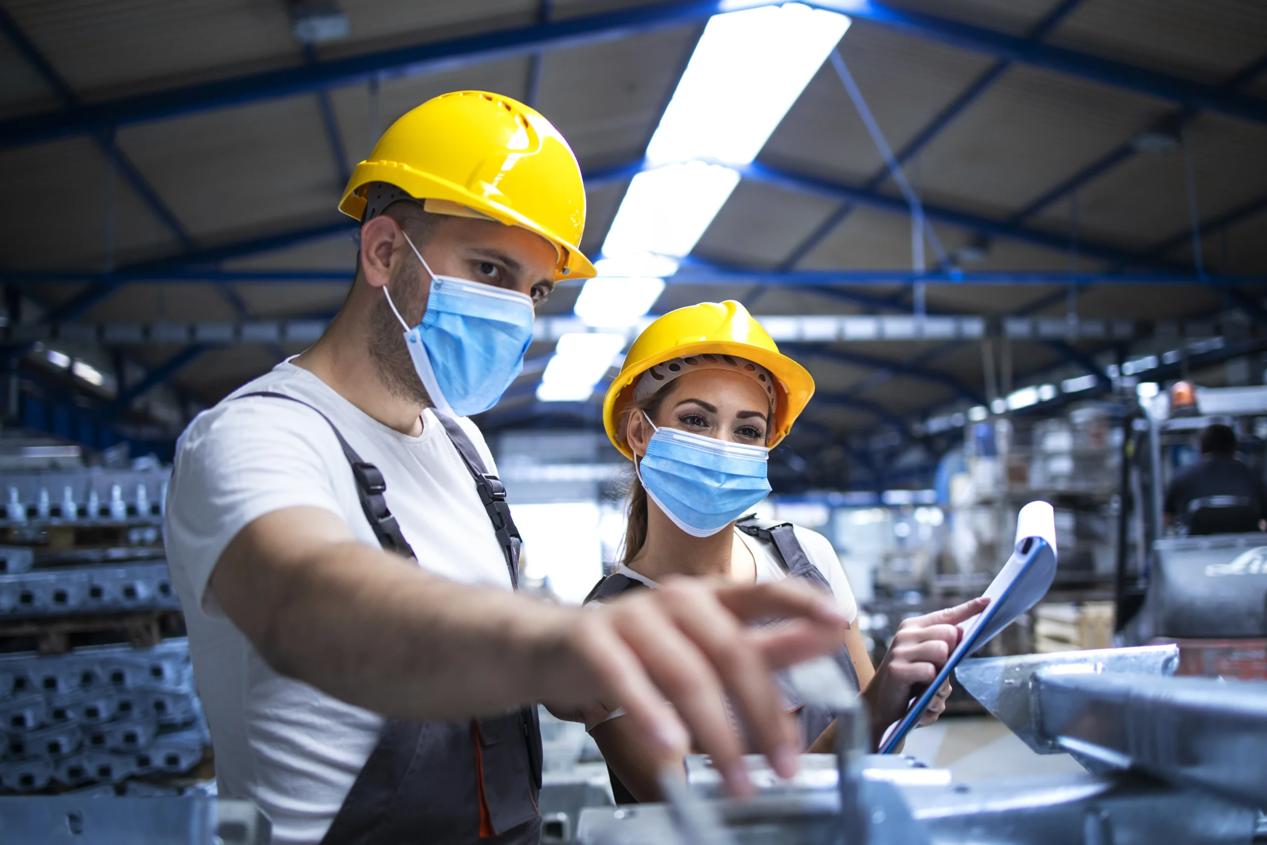 industrial-workers-discussing-about-metal-parts-factory