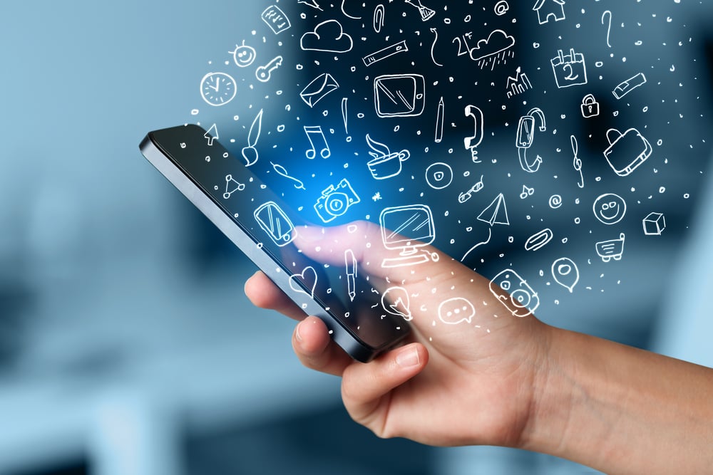 Hand20holding20smartphone20with20hand20drawn20media20icons20and20symbols20concept-1