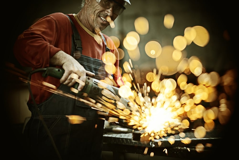 Industrial20worker20cutting20and20welding20metal20with20many20sharp20sparks-1-1