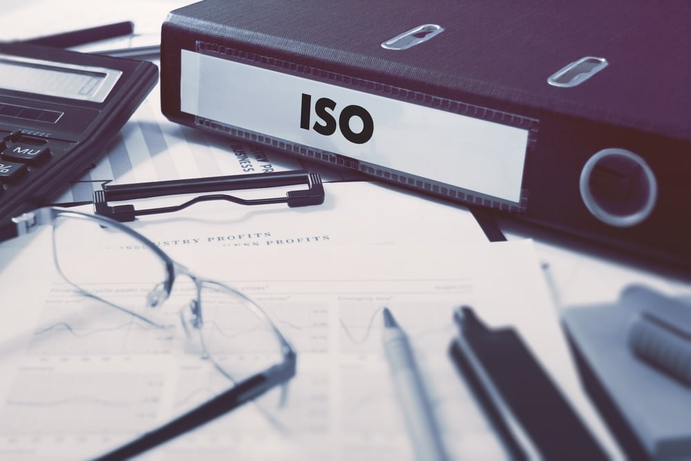 Office20folder20with20inscription20ISO20-20International20Organization20for20Standardization20-20on20Office20Desktop20with20Office20Supplies.20Business20Concept20on20Blu-2