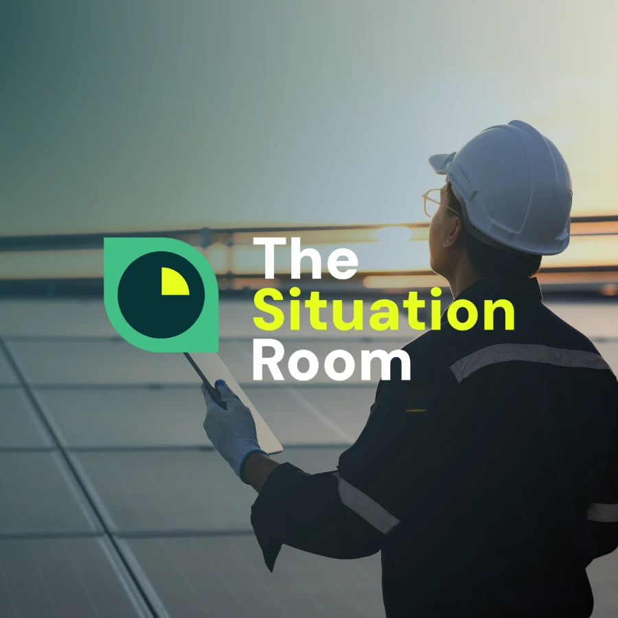 Man Holding Tablet By Solar Panels