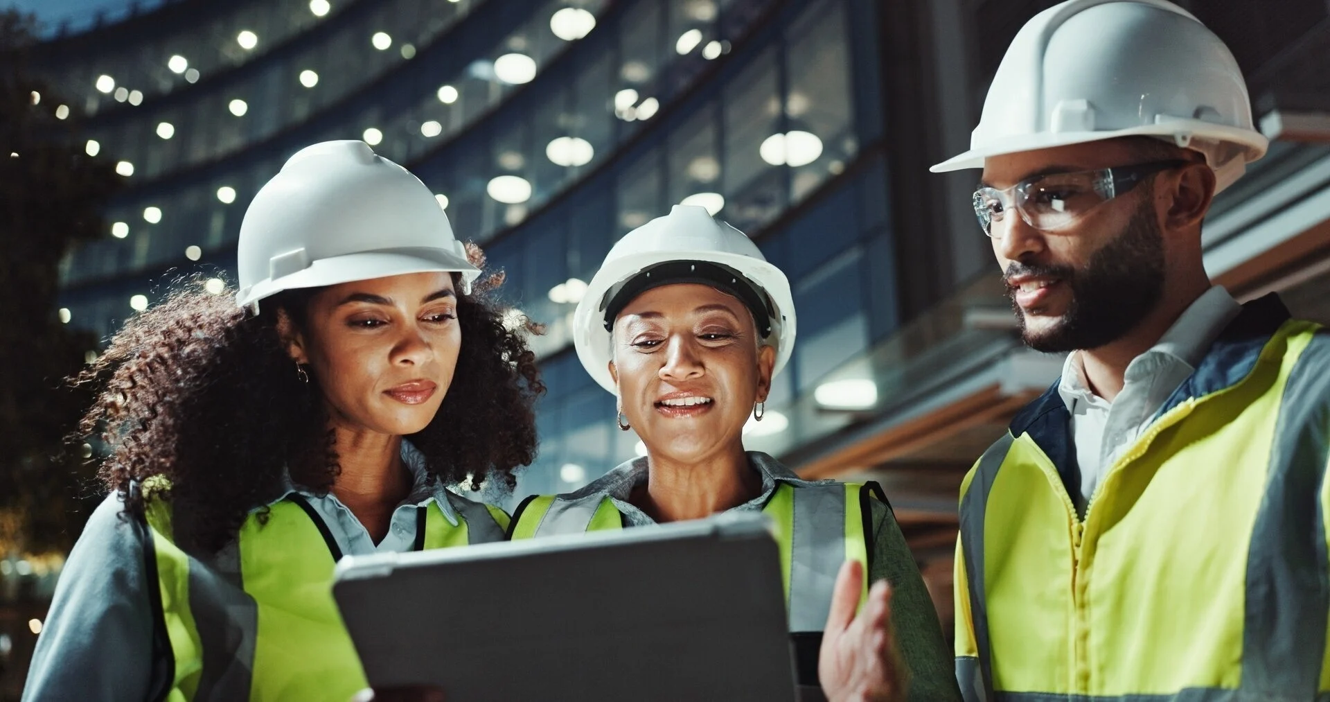 3 Employees Looking At A Tablet