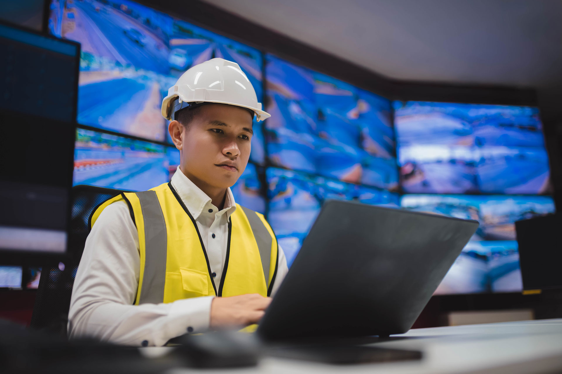 Man Working On Laptop In Control Center